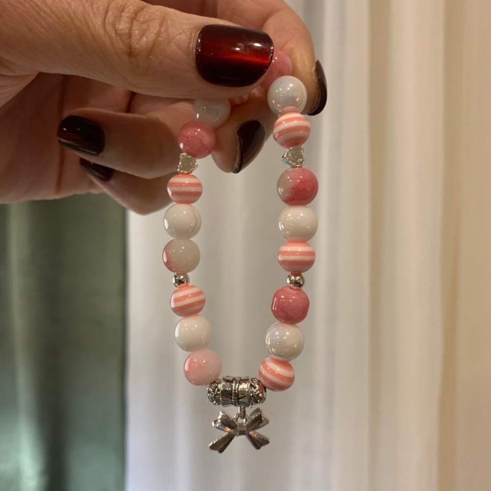 Pink and White Beaded Bracelet with Bow Charm